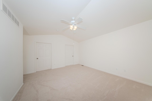 128 Commons Cir, Saline, MI 48176 - additional living space with light carpet, ceiling fan, lofted ceiling, and baseboards