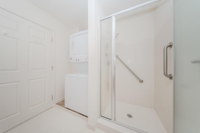 128 Commons Cir, Saline, MI 48176 - full bath with stacked washer / dryer and a stall shower