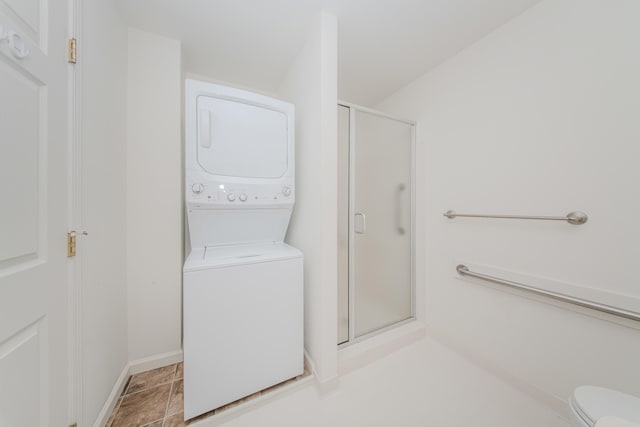 128 Commons Cir, Saline, MI 48176 - laundry room with stacked washer / dryer and baseboards