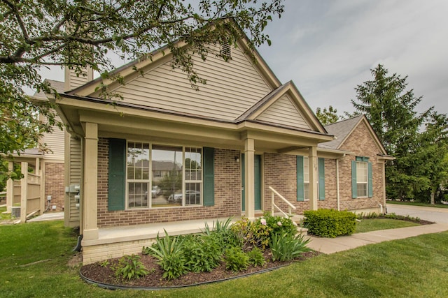 128 Commons Cir, Saline, MI 48176 - view of front facade featuring brick siding, a front lawn, and a chimney