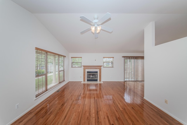 128 Commons Cir, Saline, MI 48176 - unfurnished living room featuring a fireplace, light wood-type flooring, ceiling fan, baseboards, and high vaulted ceiling