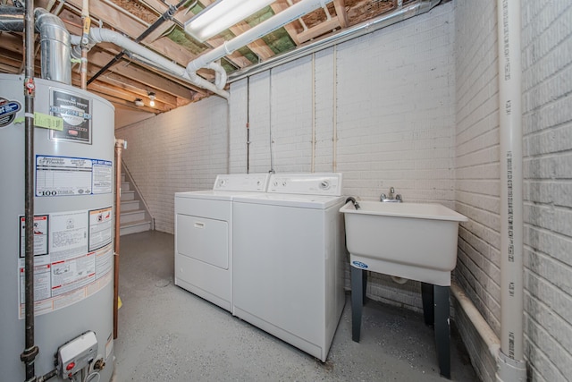 128 Commons Cir, Saline, MI 48176 - washroom with gas water heater, washer and dryer, and brick wall