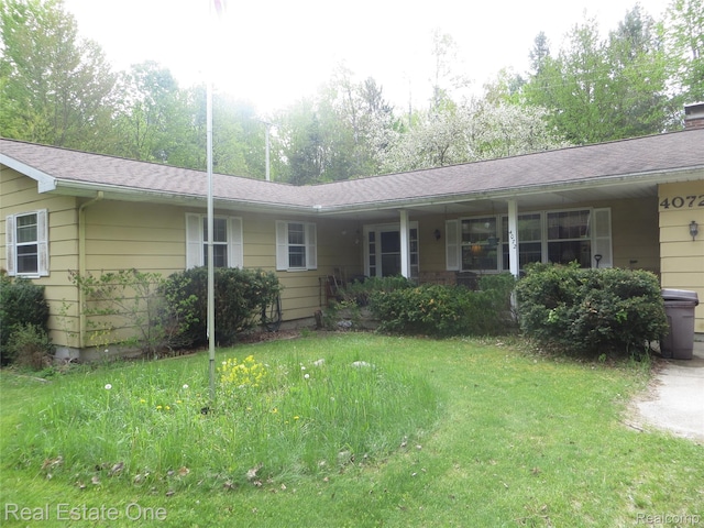 4072 M 55, Cadillac, MI 49601 - single story home featuring a front yard and a chimney