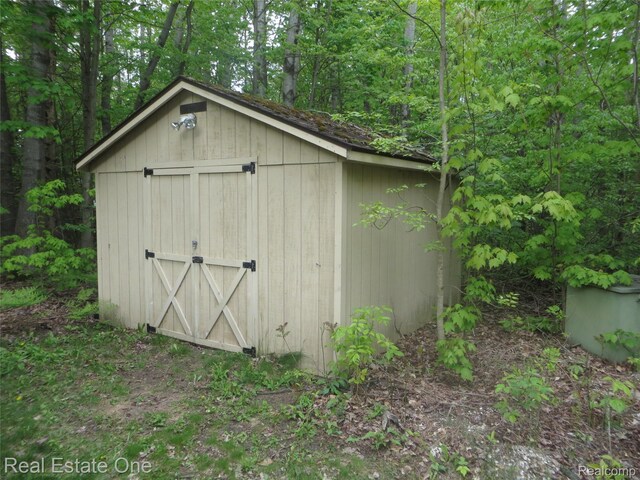 4072 M 55, Cadillac, MI 49601 - view of shed featuring a view of trees