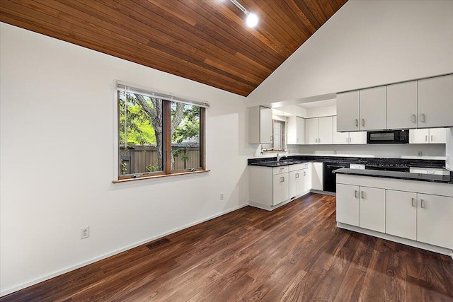2 Eastbury Ct, Ann Arbor, MI 48105 - kitchen with black microwave, wood ceiling, baseboards, white cabinets, and dark countertops