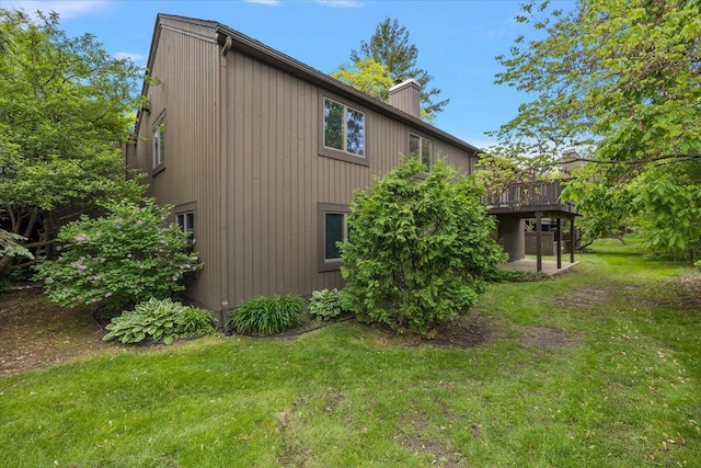 2 Eastbury Ct, Ann Arbor, MI 48105 - view of side of home featuring a yard, a chimney, and a wooden deck
