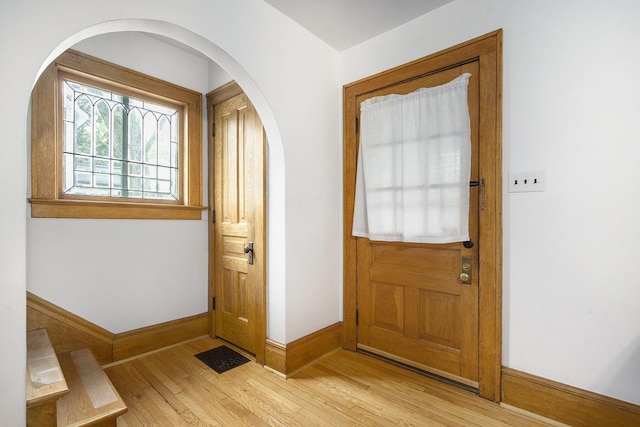 3209 Springbrook St, Ann Arbor, MI 48108 - entrance foyer featuring baseboards, wood-type flooring, and arched walkways
