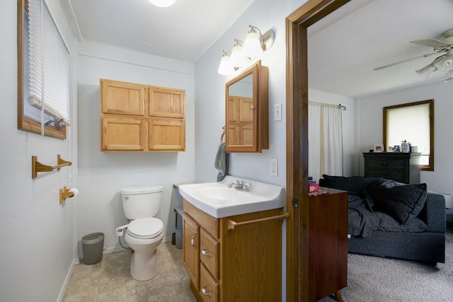 3209 Springbrook St, Ann Arbor, MI 48108 - bathroom featuring vanity, ceiling fan, toilet, and baseboards