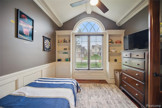 22638 Brantingham Rd, Macomb, MI 48044 - bedroom featuring a decorative wall, wainscoting, vaulted ceiling, wood finished floors, and ceiling fan