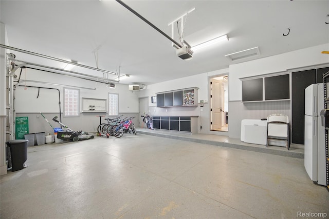 22638 Brantingham Rd, Macomb, MI 48044 - garage with freestanding refrigerator and a garage door opener