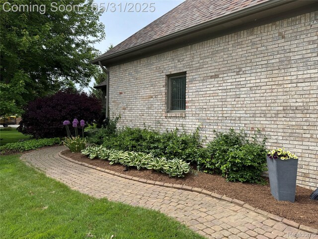7348 William Dr, Shelby Twp, MI 48316 - view of home's exterior featuring roof with shingles