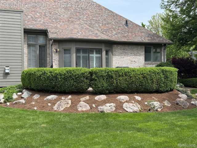 7348 William Dr, Shelby Twp, MI 48316 - view of home's exterior featuring a yard and brick siding