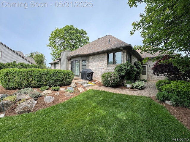 7348 William Dr, Shelby Twp, MI 48316 - back of property with brick siding, a yard, and roof with shingles
