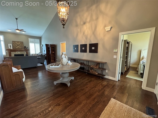 7348 William Dr, Shelby Twp, MI 48316 - dining space featuring high vaulted ceiling, a fireplace, wood finished floors, baseboards, and ceiling fan