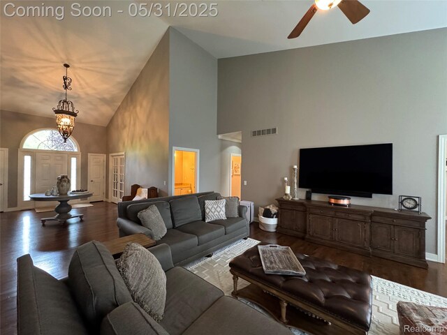7348 William Dr, Shelby Twp, MI 48316 - living room featuring high vaulted ceiling, wood finished floors, a ceiling fan, baseboards, and a chandelier
