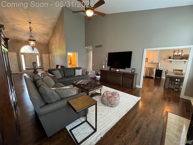 7348 William Dr, Shelby Twp, MI 48316 - living room with high vaulted ceiling, a ceiling fan, dark wood-style flooring, baseboards, and a chandelier