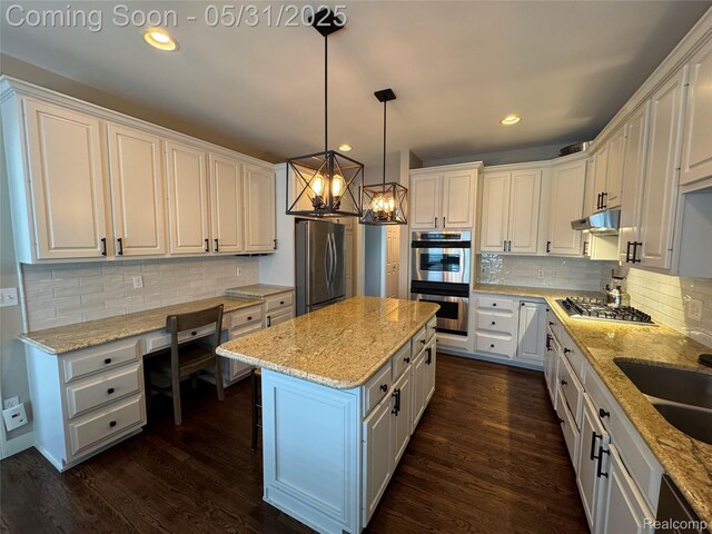 7348 William Dr, Shelby Twp, MI 48316 - kitchen with appliances with stainless steel finishes, under cabinet range hood, a chandelier, white cabinets, and recessed lighting