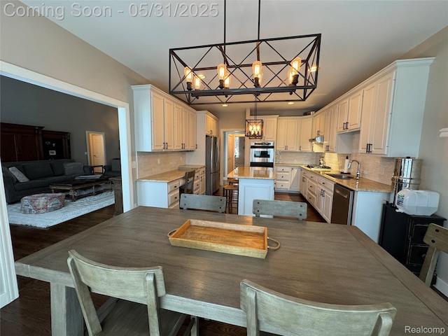 7348 William Dr, Shelby Twp, MI 48316 - dining area with a chandelier and dark wood-style floors