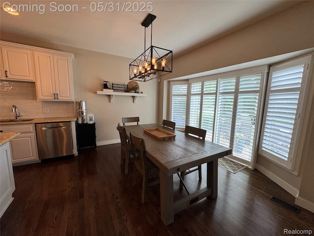 7348 William Dr, Shelby Twp, MI 48316 - dining room featuring baseboards, a chandelier, healthy amount of natural light, and dark wood-type flooring