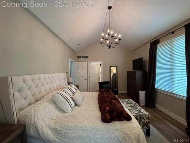 7348 William Dr, Shelby Twp, MI 48316 - bedroom with a chandelier, wood finished floors, vaulted ceiling, and baseboards