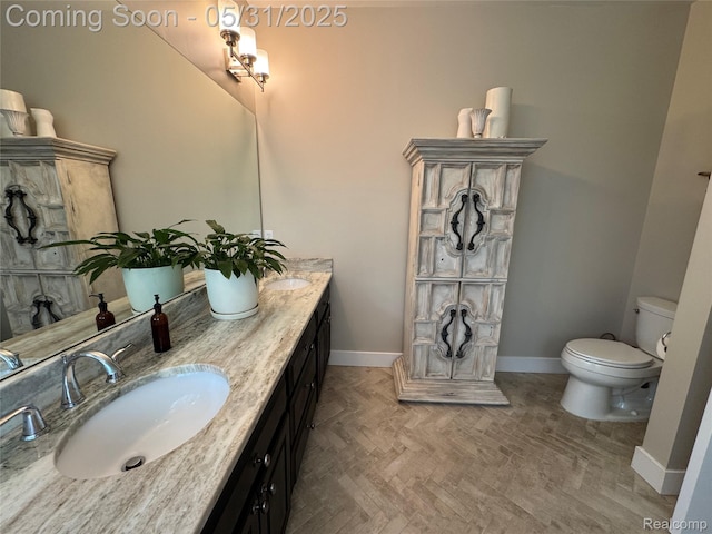7348 William Dr, Shelby Twp, MI 48316 - bathroom with baseboards, toilet, and double vanity