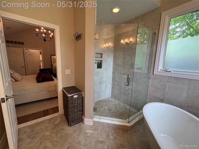 7348 William Dr, Shelby Twp, MI 48316 - bathroom featuring a freestanding tub, ensuite bath, a shower stall, and a chandelier