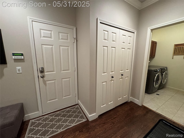 7348 William Dr, Shelby Twp, MI 48316 - laundry area with washing machine and dryer, cabinet space, dark wood finished floors, ornamental molding, and baseboards