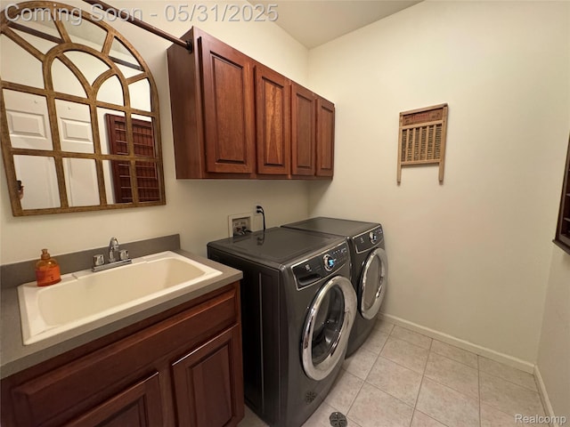 7348 William Dr, Shelby Twp, MI 48316 - laundry area featuring cabinet space, separate washer and dryer, baseboards, and light tile patterned floors