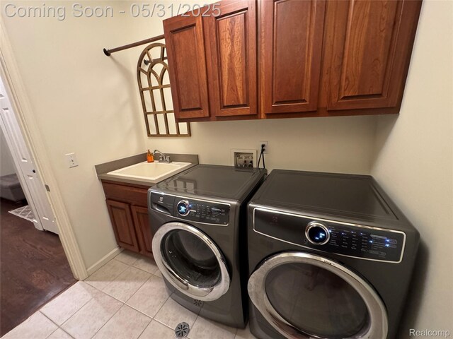 7348 William Dr, Shelby Twp, MI 48316 - washroom with washing machine and dryer, cabinet space, light tile patterned floors, and baseboards