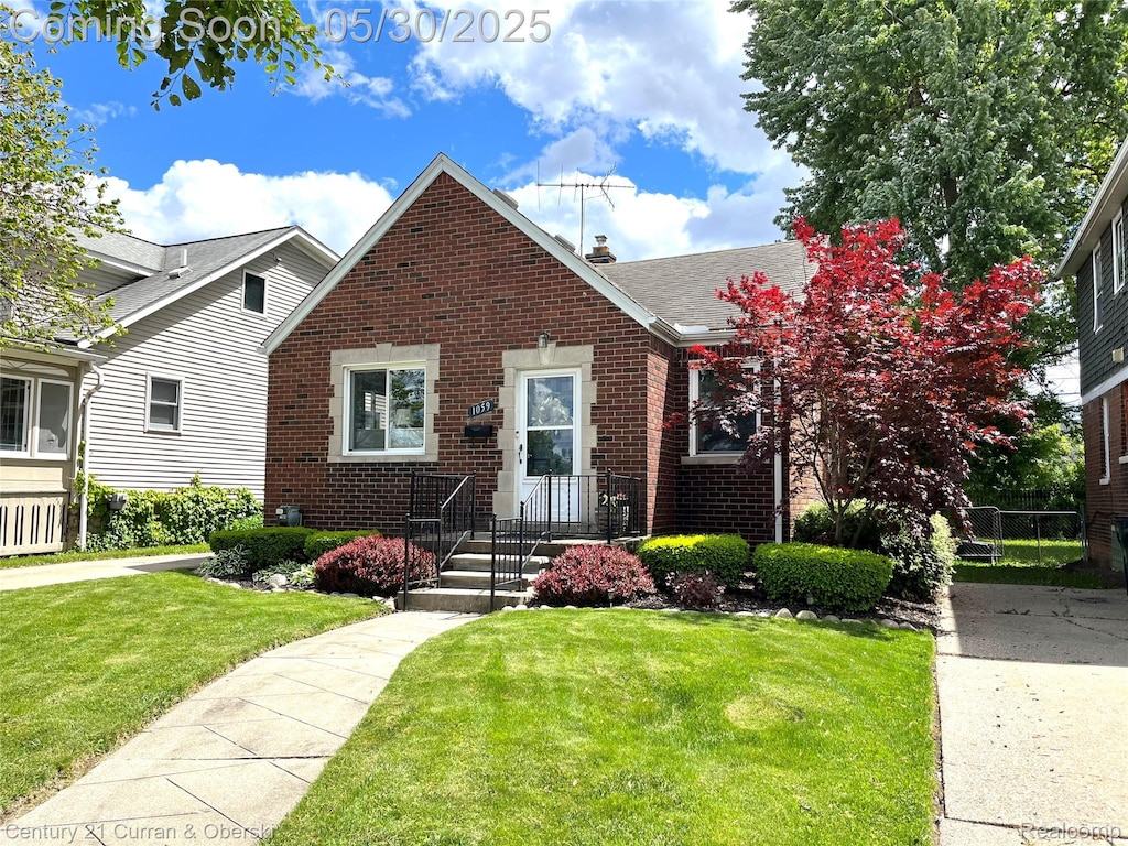 1059 Eaton Rd, Berkley, MI 48072 - view of front of house with brick siding and a front lawn