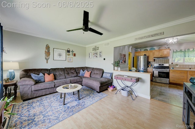 2470 E Highland Rd, Howell, MI 48843 - living area with crown molding, ceiling fan, and light wood finished floors