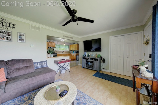 2470 E Highland Rd, Howell, MI 48843 - living area featuring light wood finished floors, crown molding, and a ceiling fan