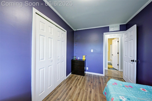 2470 E Highland Rd, Howell, MI 48843 - bedroom featuring crown molding, wood finished floors, baseboards, and a closet
