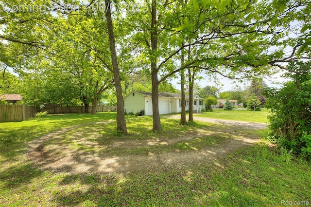 2470 E Highland Rd, Howell, MI 48843 - view of yard with an attached garage