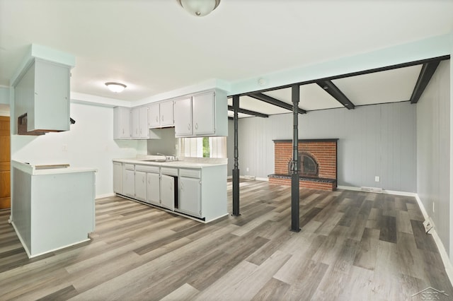3637 Cora St, Saginaw, MI 48601 - kitchen with light countertops, a sink, light wood-style floors, baseboards, and beamed ceiling