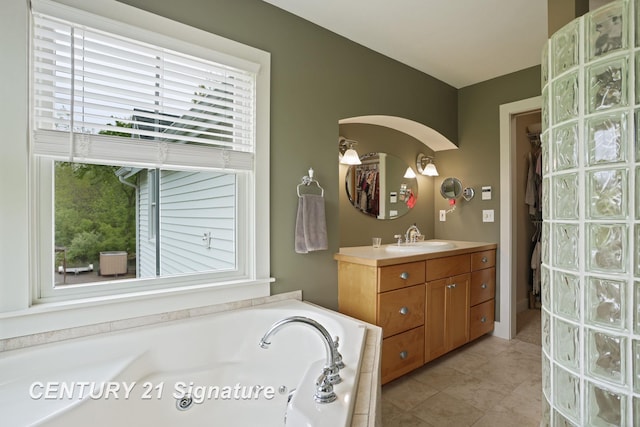 12751 Wilkinson Rd, Freeland, MI 48623 - bathroom featuring healthy amount of natural light, vanity, a bath, and tile patterned floors