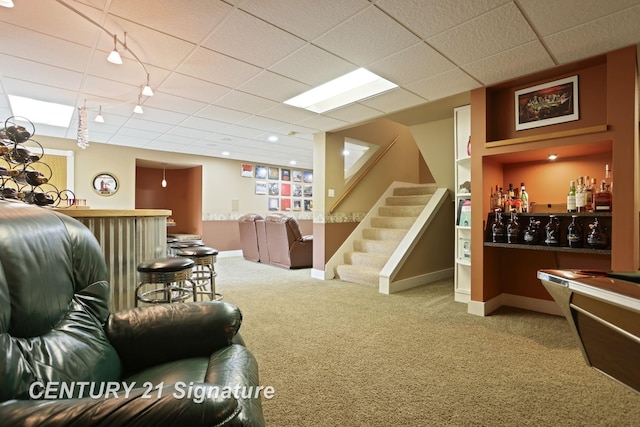 12751 Wilkinson Rd, Freeland, MI 48623 - carpeted living area with a bar, rail lighting, stairway, a paneled ceiling, and baseboards