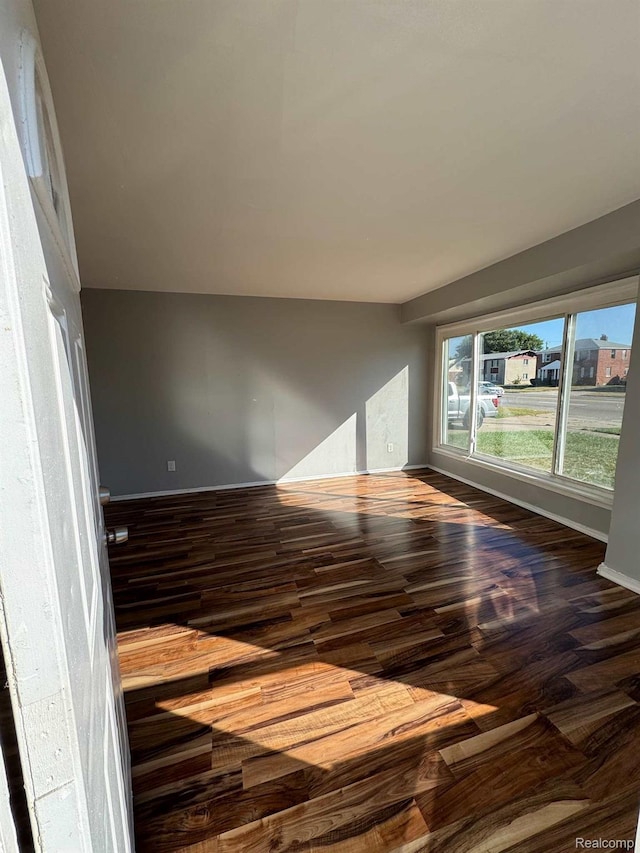 19961 Greenfield Rd, Detroit, MI 48235 - unfurnished room with dark wood-type flooring and baseboards