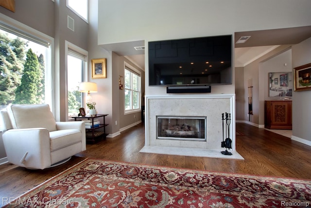 826 Wolverine Dr, Wolverine Lake, MI 48390 - living room featuring wood finished floors, baseboards, and a high end fireplace