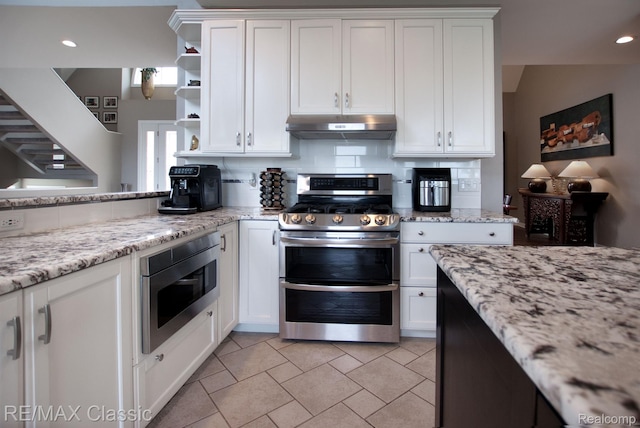 826 Wolverine Dr, Wolverine Lake, MI 48390 - kitchen with stainless steel appliances, under cabinet range hood, white cabinets, open shelves, and recessed lighting