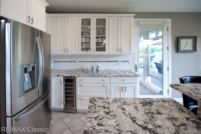 826 Wolverine Dr, Wolverine Lake, MI 48390 - kitchen with stainless steel fridge with ice dispenser, beverage cooler, white cabinets, glass insert cabinets, and decorative backsplash