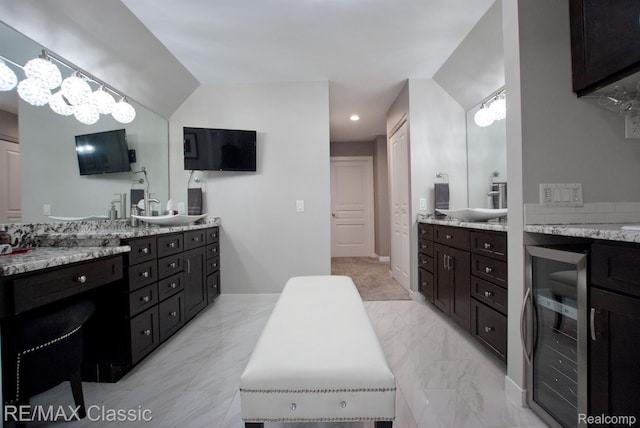 826 Wolverine Dr, Wolverine Lake, MI 48390 - bathroom featuring beverage cooler, two vanities, and marble finish floors
