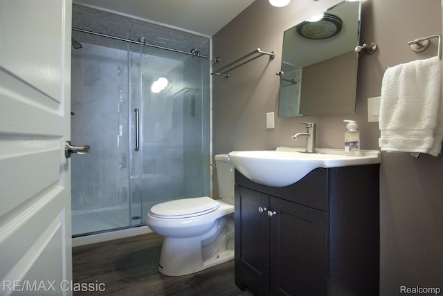 826 Wolverine Dr, Wolverine Lake, MI 48390 - full bath featuring vanity, a shower stall, wood finished floors, and toilet