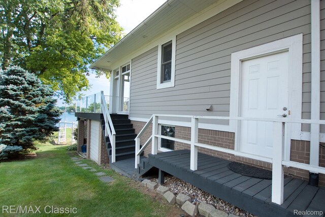 826 Wolverine Dr, Wolverine Lake, MI 48390 - deck featuring a yard and stairs