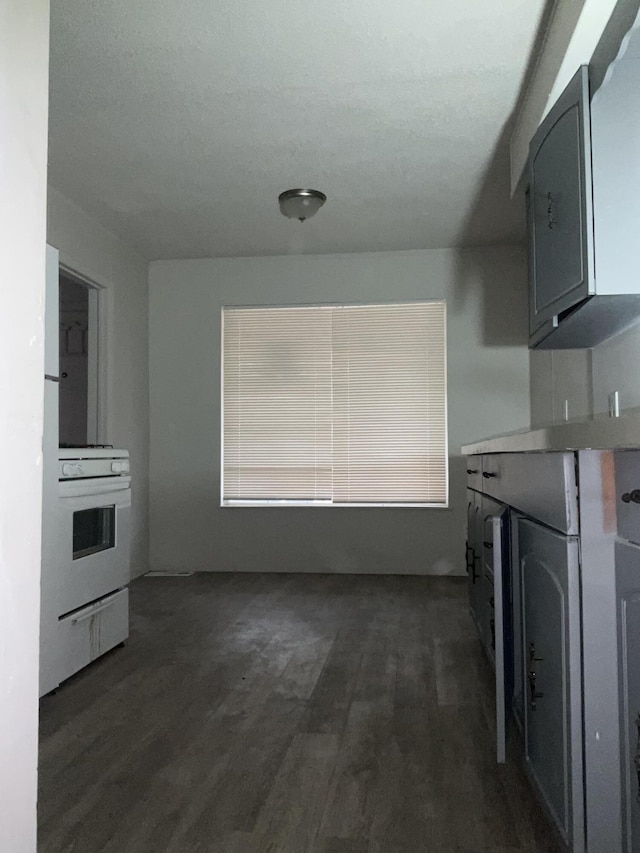 7269 Minock St, Detroit, MI 48228 - kitchen featuring white electric range, dark wood finished floors, and light countertops