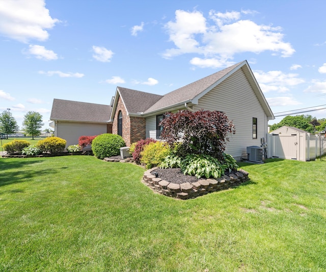826 Jennie Pl, Monroe, MI 48161 - view of side of property featuring central air condition unit, a yard, roof with shingles, and brick siding