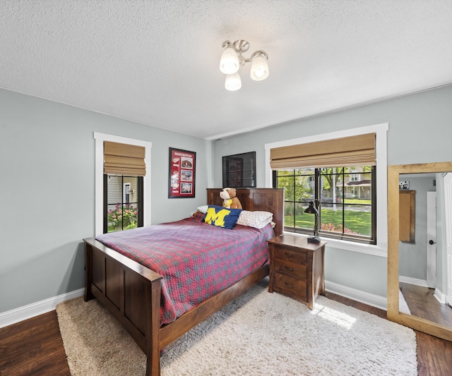 826 Jennie Pl, Monroe, MI 48161 - bedroom featuring baseboards, wood finished floors, and a textured ceiling