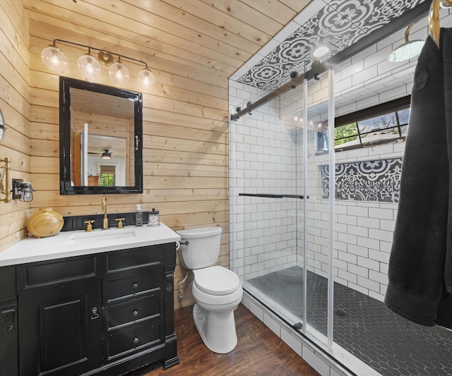 826 Jennie Pl, Monroe, MI 48161 - full bathroom with wooden walls, toilet, vanity, wood finished floors, and a stall shower