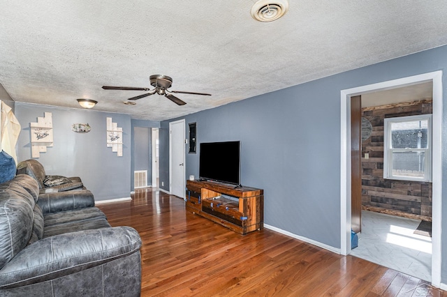 4411 W Michigan Ave, Saginaw, MI 48638 - living room with wood-type flooring, a ceiling fan, and a textured ceiling