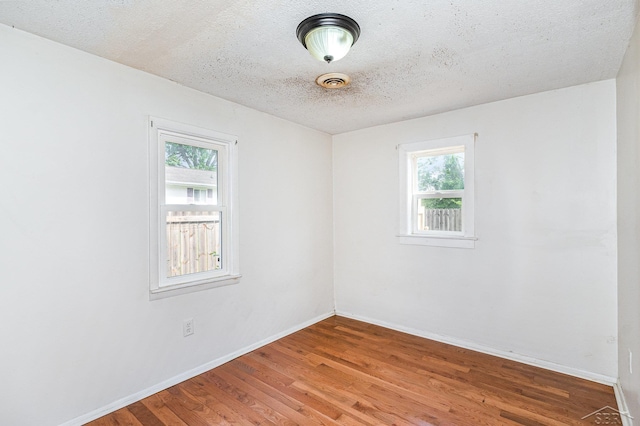 4411 W Michigan Ave, Saginaw, MI 48638 - unfurnished room with wood finished floors and a textured ceiling